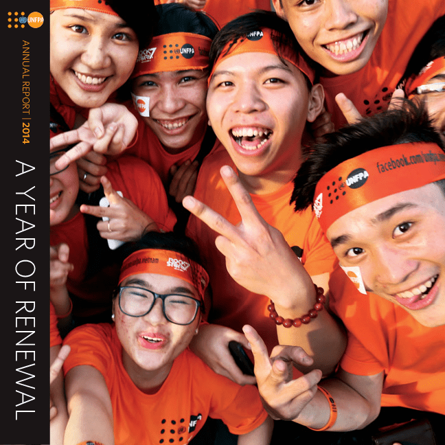 Five young people in orange T-shirts smile as they take a selfie